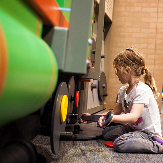 girl changing Percy's wheel in the exhibit